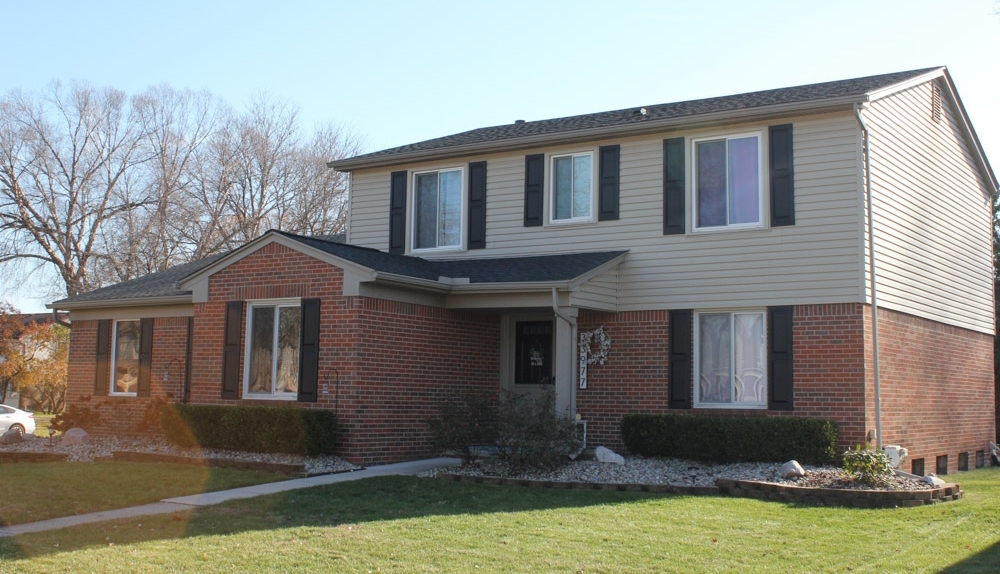large house with a new roof after the roofing replacement service