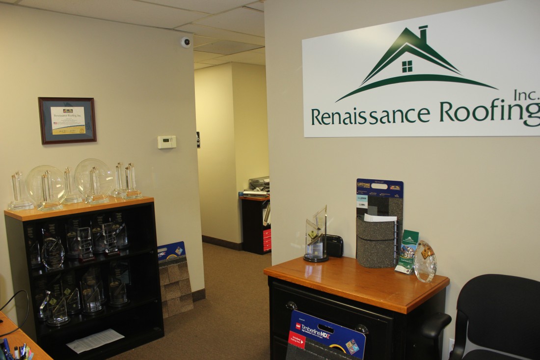 Renaissance Roofing's office with certifications on the walls and awards on the table